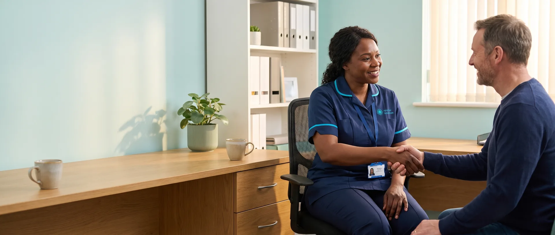 Sunrise Total Care manager welcoming a new applicant to a friendly care job interview at the local office